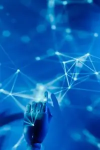 Futuristic robotic hand touching a digital network on a blue background.